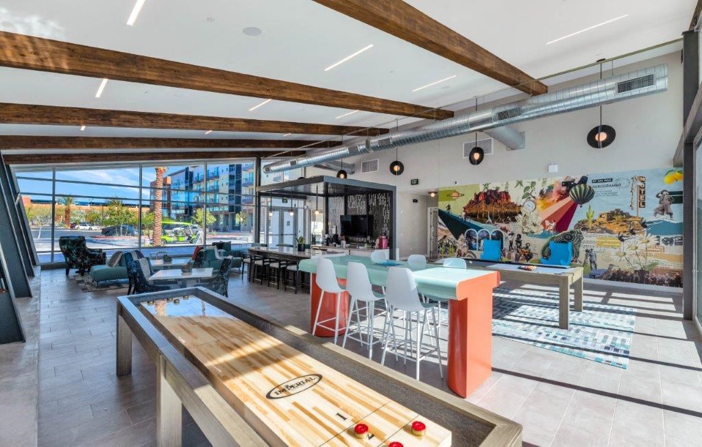 a game room with tables and chairs and a pool table