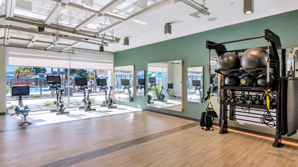 a gym with weights and other equipment in a large room