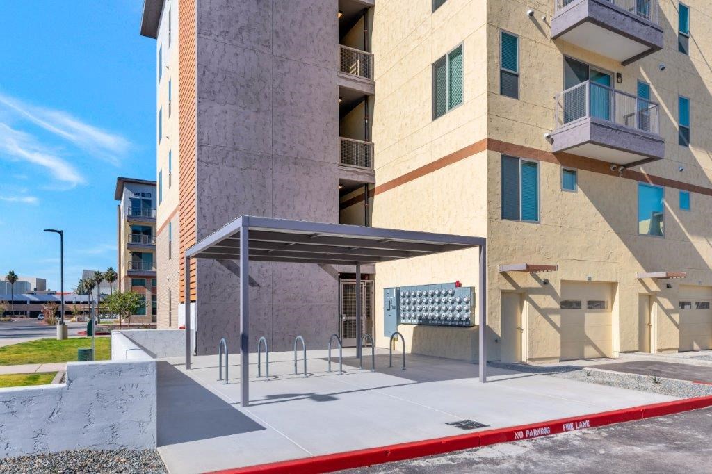 a covered bus stop in front of a building