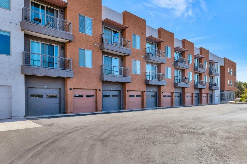 an empty parking lot in front of an apartment building