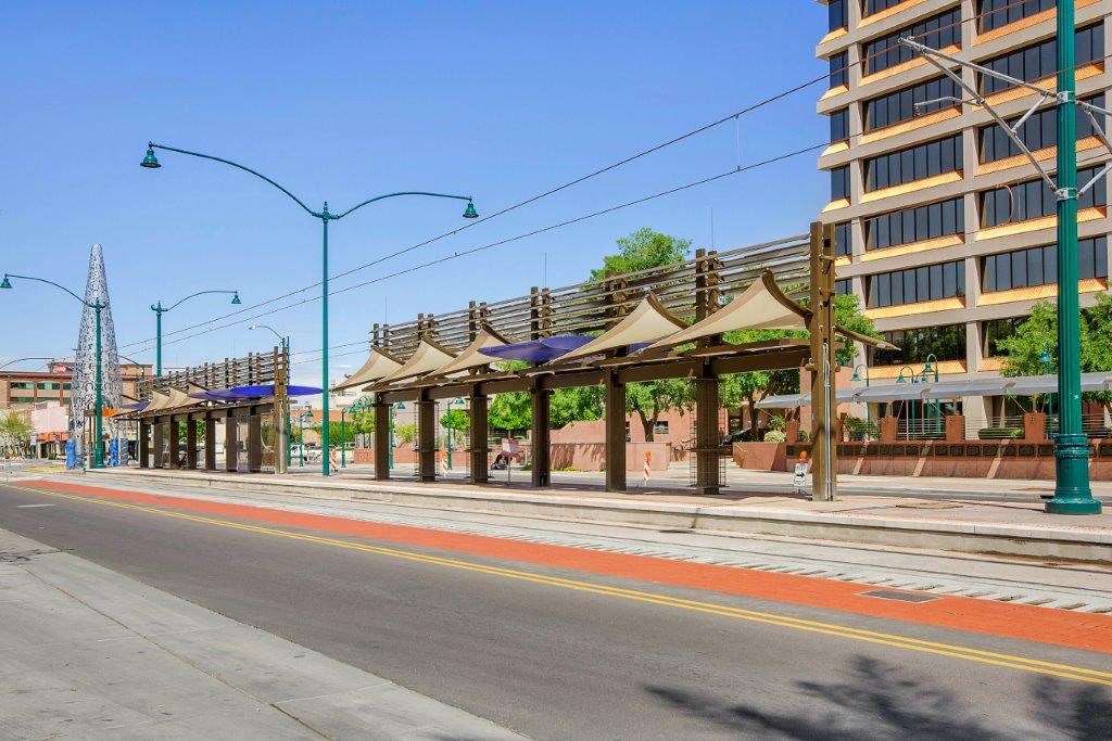a street with a row of umbrellas on the sidewalk