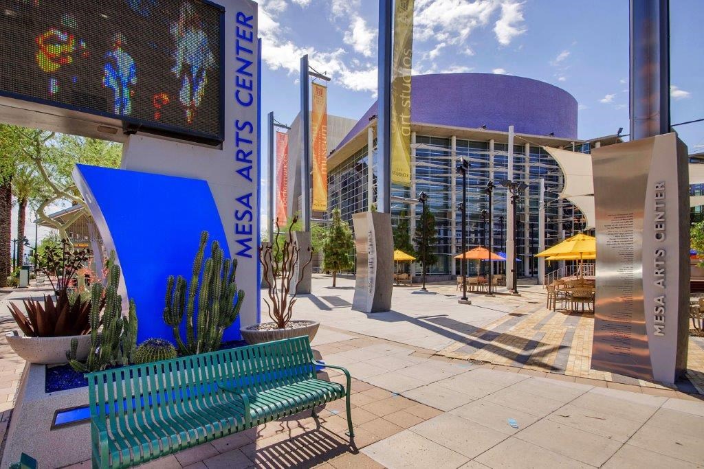 a city street with a bench and a large building