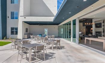 a patio with tables and chairs  at Glen 91, Glendale, 85305