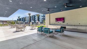 a patio with chairs and tables and a bar   at Glen 91, Glendale, AZ