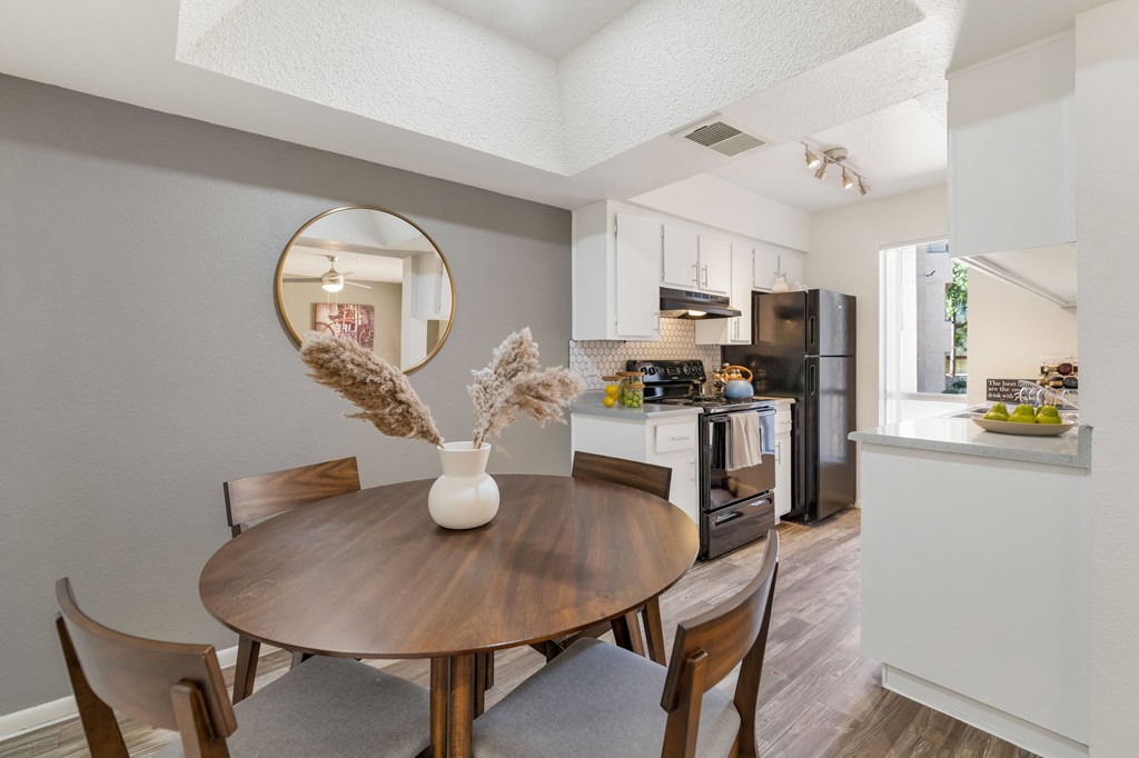 a dining room and kitchen with a table and chairs  at Glen Brae, Glendale, AZ, 85301