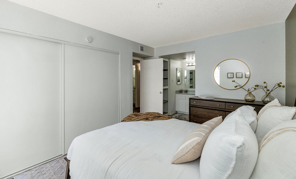 a bedroom with a large white bed and a bathroom  at Glen Brae, Arizona, 85301
