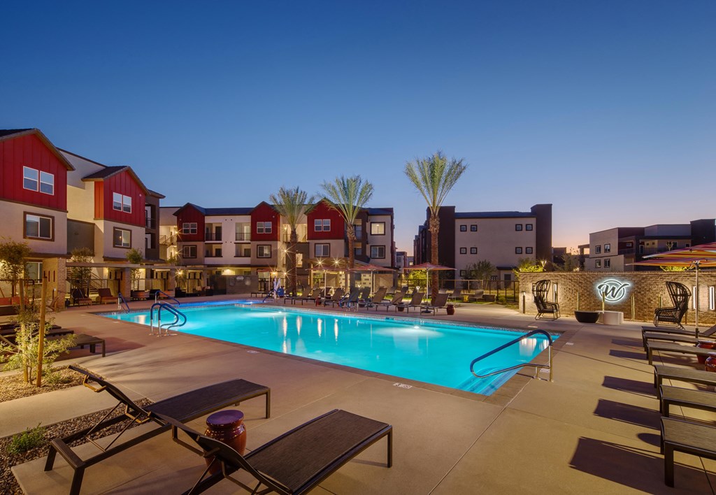 a swimming pool at night with apartments in the background at Weylyn Luxury Apartments, Arizona, 85339