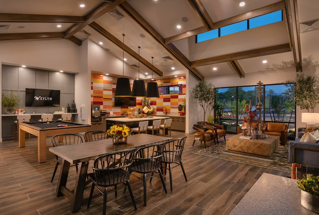 a dining room with a table and chairs and a kitchen with a large windowat Weylyn Luxury Apartments, Laveen, AZ