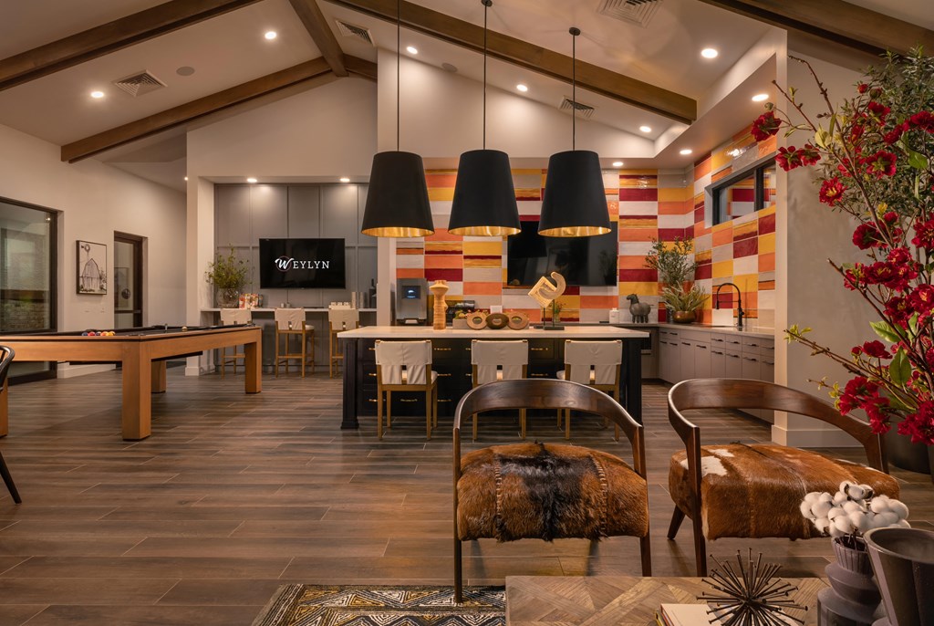 the lobby of a clubhouse with tables and chairs and a pool tableat Weylyn Luxury Apartments, Laveen, AZ