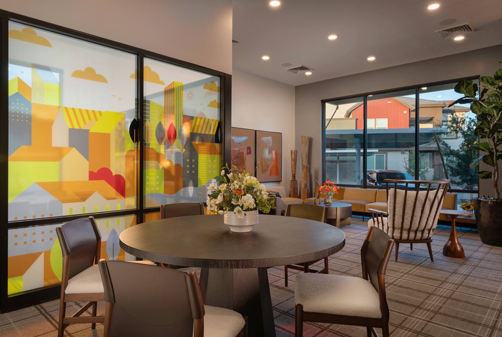 a dining room with tables and chairs and large windows at Weylyn Luxury Apartments, Laveen, 85339