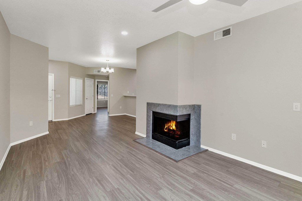 an empty living room with a fireplace in it