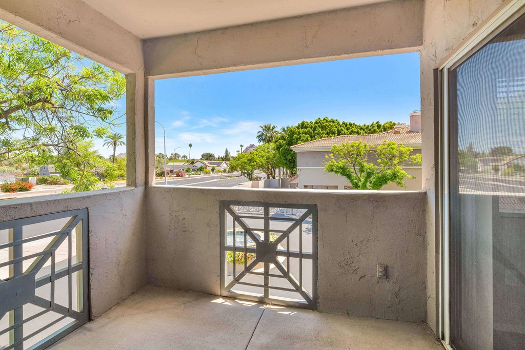 a balcony with a door and a view of the street