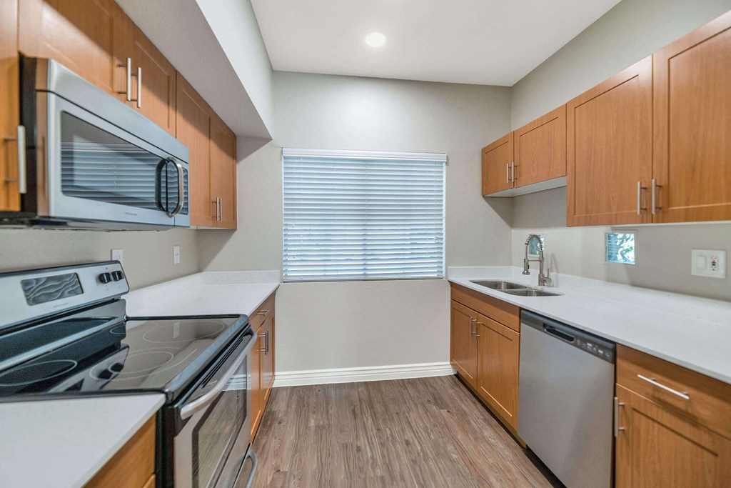 a modern kitchen with wood cabinets and stainless steel appliances