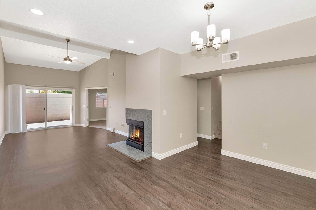the living room has a fireplace and hardwood floors