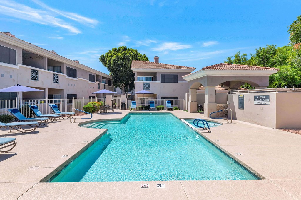 a swimming pool with a building in the background