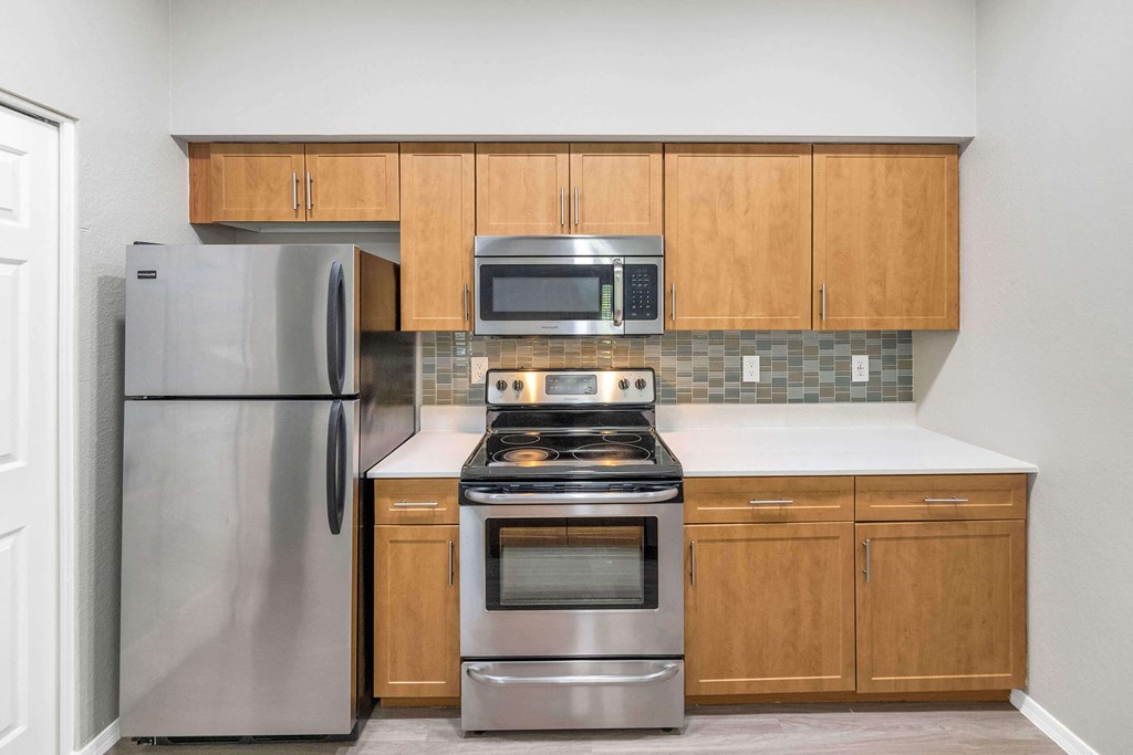 a kitchen with stainless steel appliances and wooden cabinets