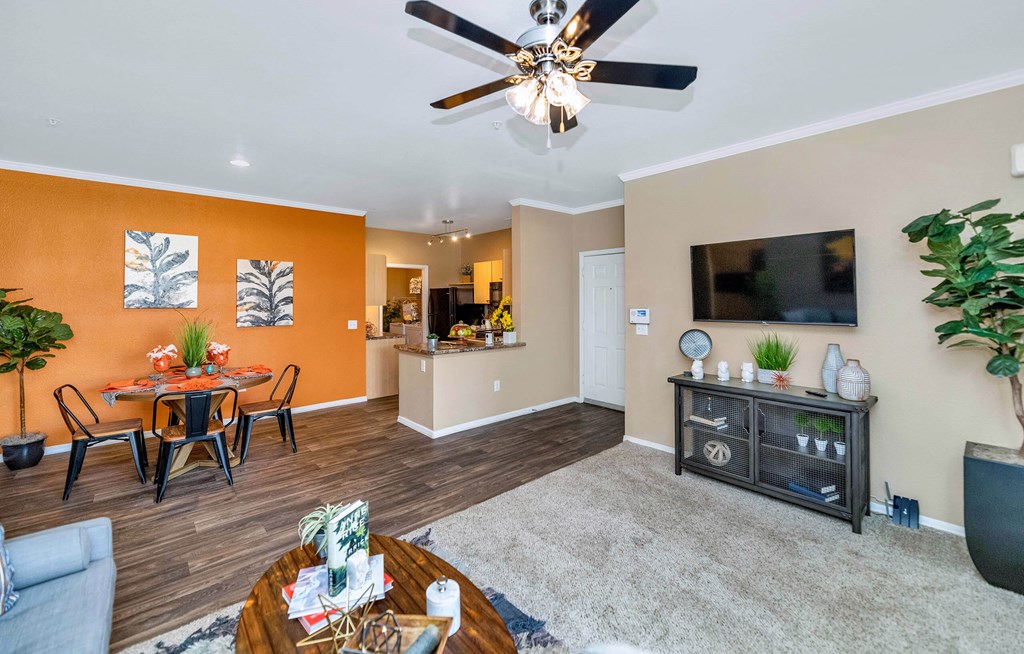 A living room with a dining table and chairs at Montage at Pecos Ranch Apartments, Chandler