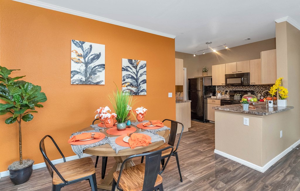 A dining room with a table set for a meal at Montage at Pecos Ranch Apartments, Arizona