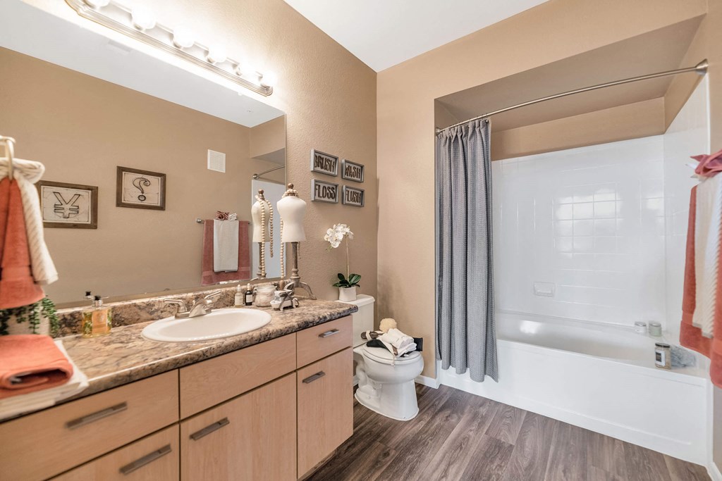 A bathroom with a sink, toilet, and bathtub at Montage at Pecos Ranch Apartments, Chandler, AZ, 85286