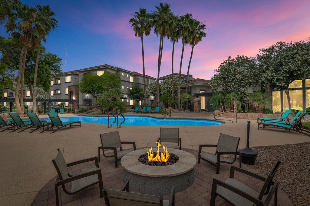 A fire pit sits in the middle of a patio at Montage at Pecos Ranch Apartments, Arizona, 85286