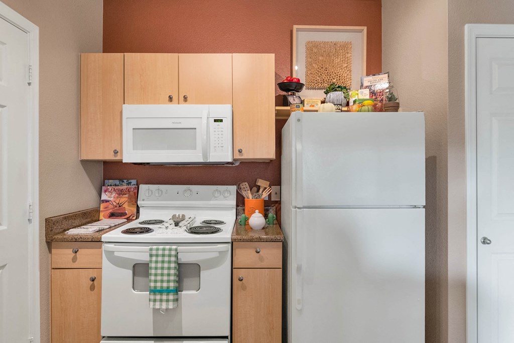 A kitchen with a white stove and a white refrigerator at Montage at Pecos Ranch Apartments, Chandler, 85286