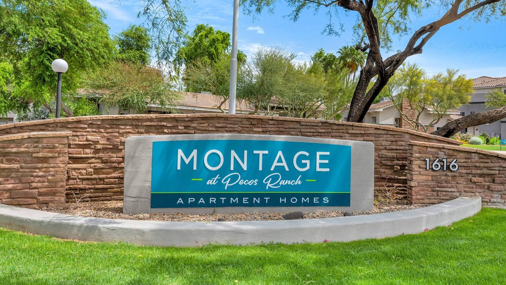 A sign for Montage at Peccary Ranch Apartment Homes is displayed in front of a grassy area at Montage at Pecos Ranch Apartments, Chandler, AZ, 85286