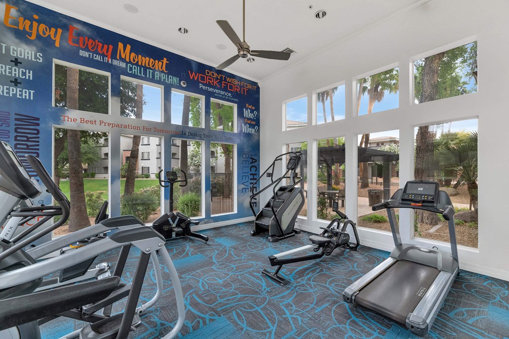 a gym with cardio equipment and windows at the resort at longboat key club at Montage at Pecos Ranch Apartments, Chandler, 85286