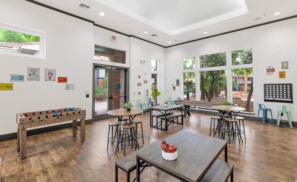 A room with a wooden bench and a table with a vase of flowers on it at Montage at Pecos Ranch Apartments, Chandler, Arizona