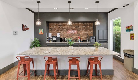 a kitchen with a marble counter top and bar stools