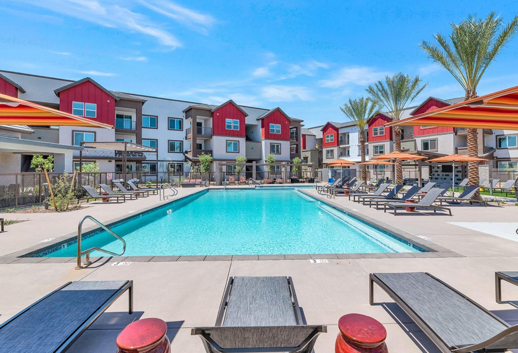 our apartments have a swimming pool with lounge chairs and umbrellasat Weylyn Luxury Apartments, Arizona