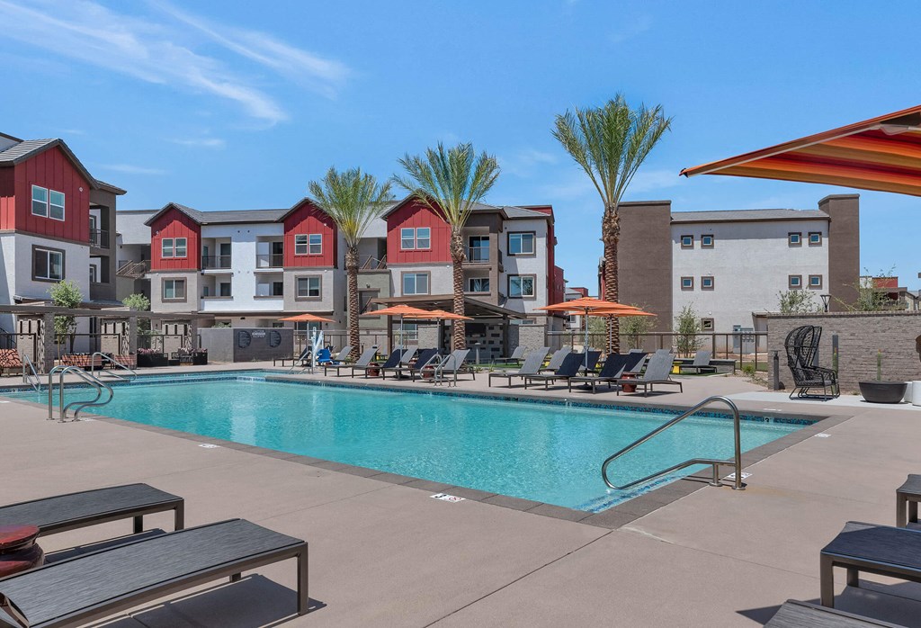 our apartments have a swimming pool with chairs and umbrellasat Weylyn Luxury Apartments, Laveen, AZ