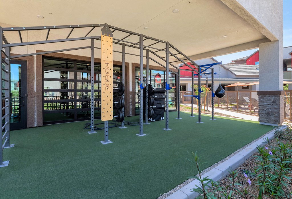 a fitness center with weights and other equipment in a buildingat Weylyn Luxury Apartments, Arizona, 85339