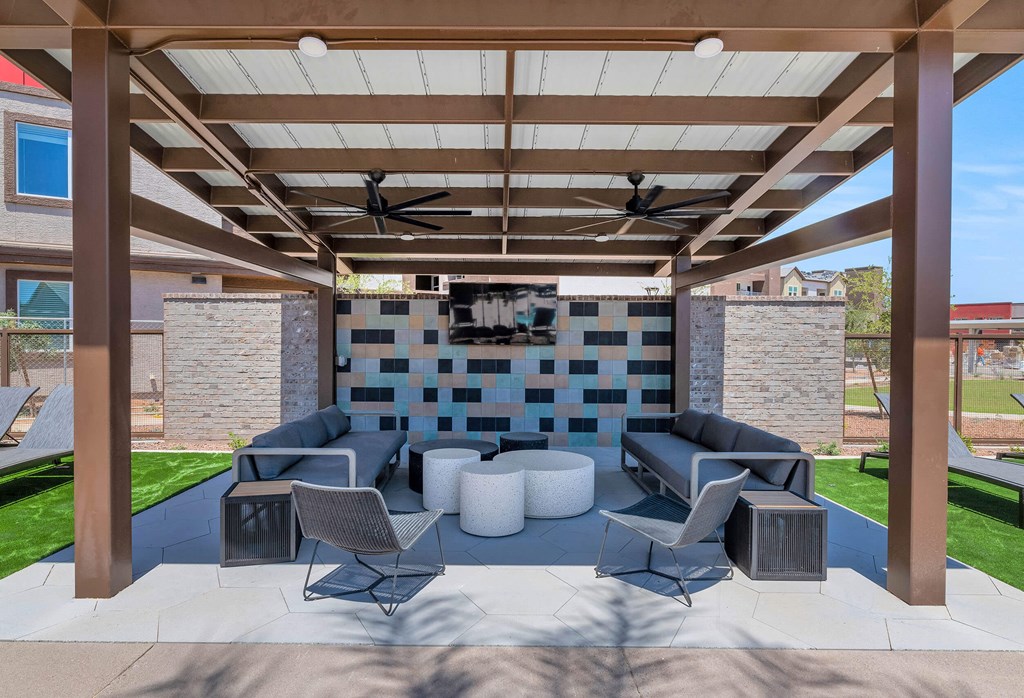 a covered patio with couches and chairs and a televisionat Weylyn Luxury Apartments, Laveen