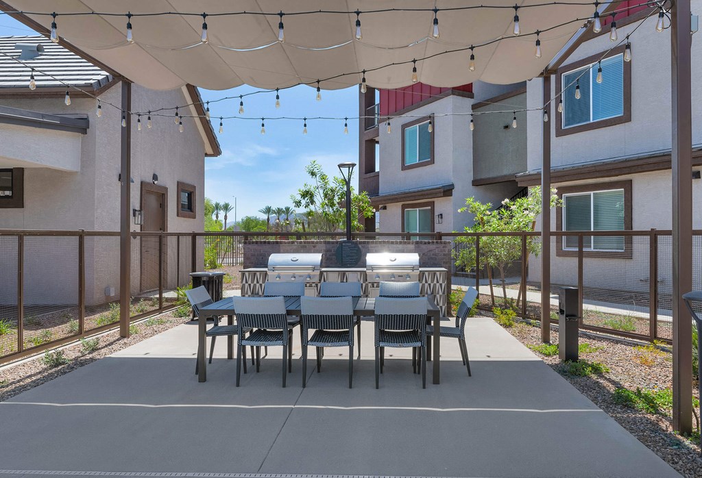 a patio with a dining table and chairs under a canopyat Weylyn Luxury Apartments, Laveen