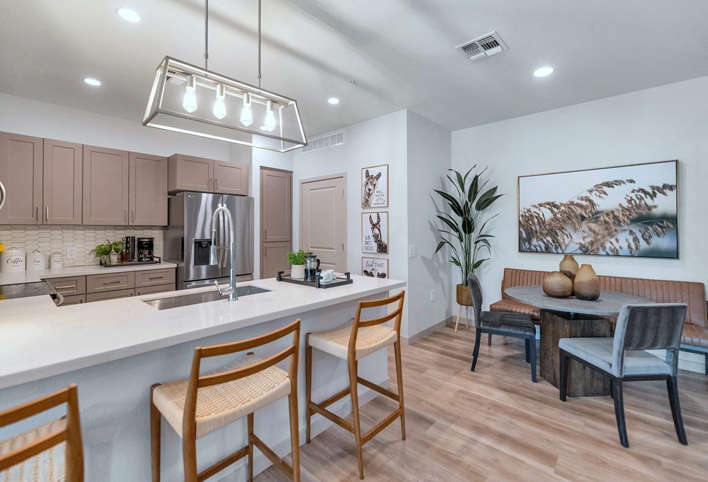 a kitchen and dining room with a table and chairs at Weylyn Luxury Apartments, Laveen, Arizona