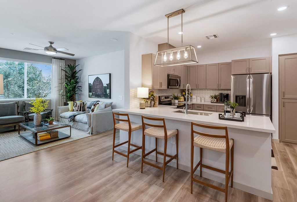 a kitchen and living room in an open floor planat Weylyn Luxury Apartments, Laveen, AZ