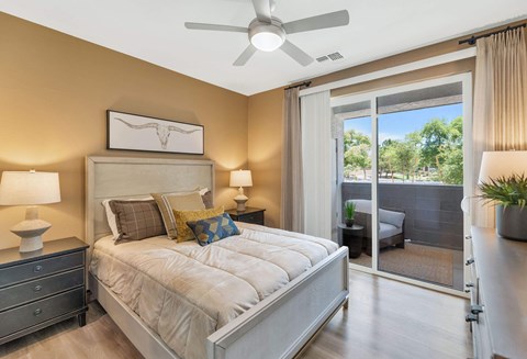 a bedroom with a bed and a ceiling fanat Weylyn Luxury Apartments, Laveen, AZ 85339