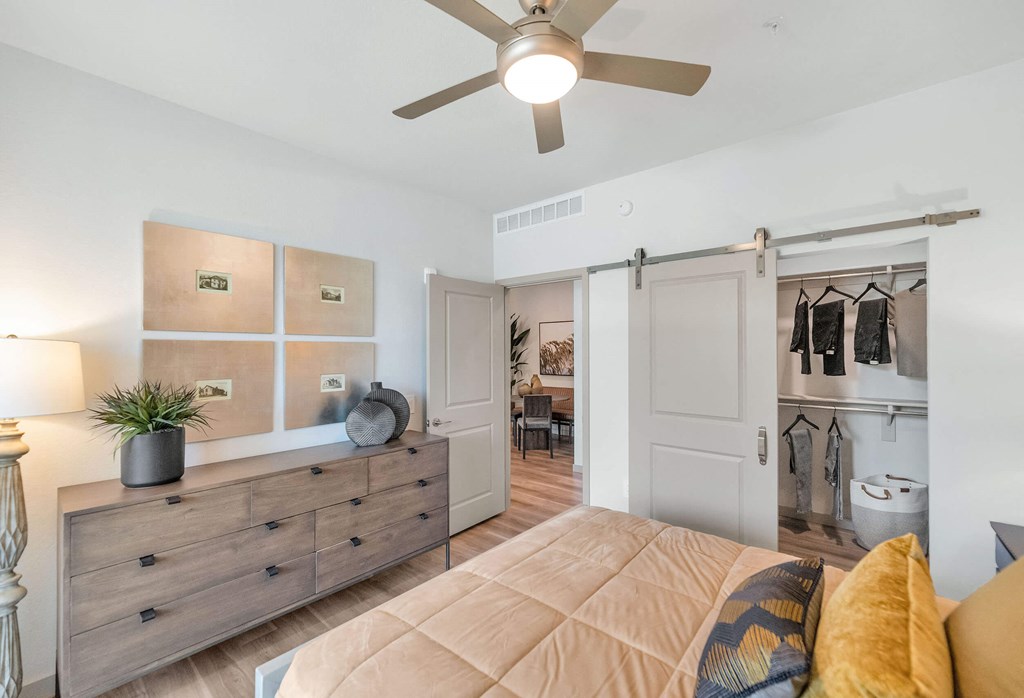 a bedroom with a ceiling fan and a closetat Weylyn Luxury Apartments, Laveen, AZ