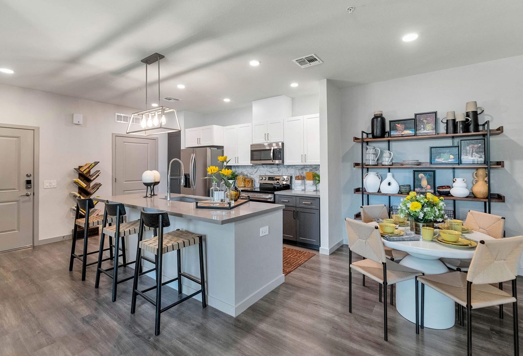 a kitchen and dining room with a table and chairsat Weylyn Luxury Apartments, Laveen, AZ 85339