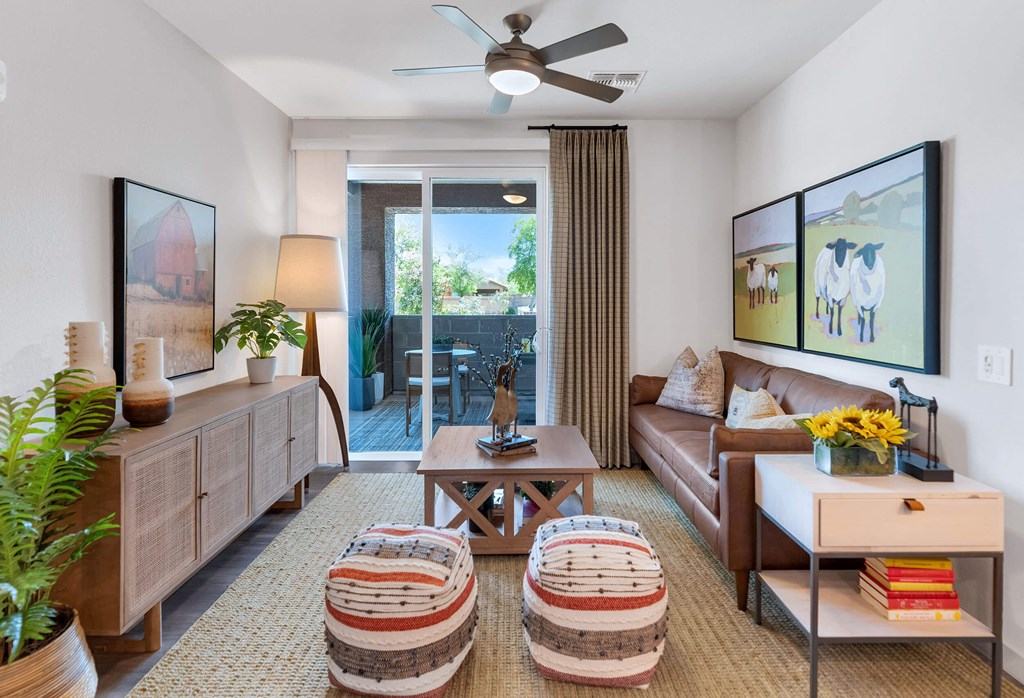 a living room with a couch and a ceiling fanat Weylyn Luxury Apartments, Laveen, AZ