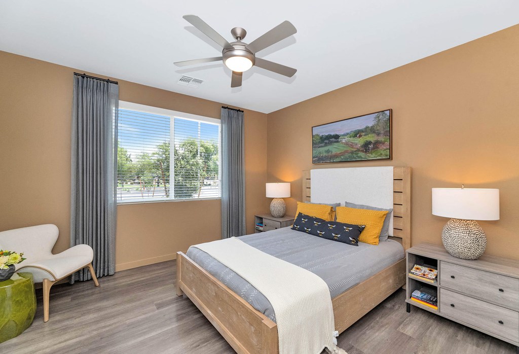 a bedroom with a bed and a ceiling fanat Weylyn Luxury Apartments, Arizona