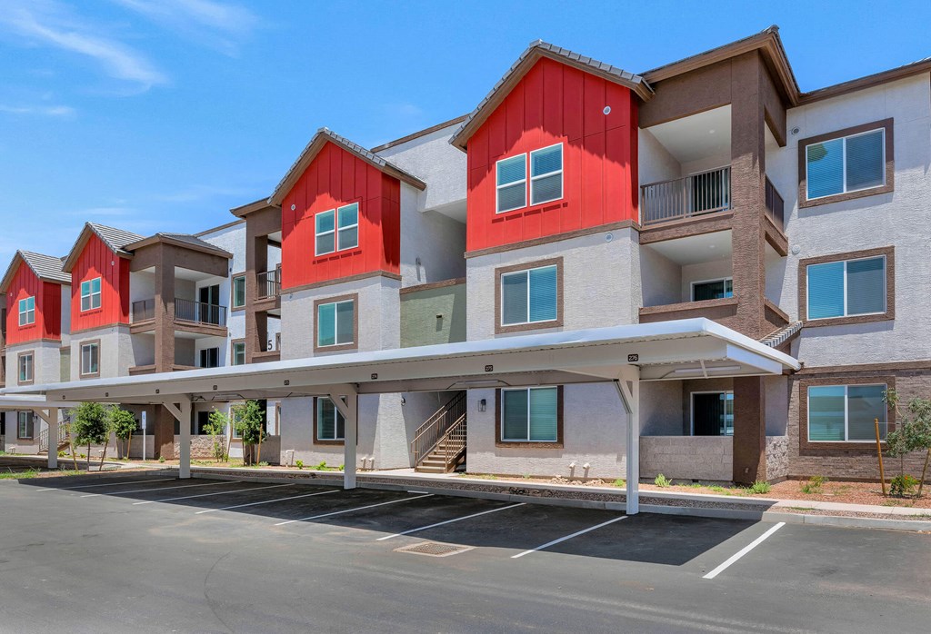an empty parking lot in front of a row of apartment buildings at Weylyn Luxury Apartments, Arizona