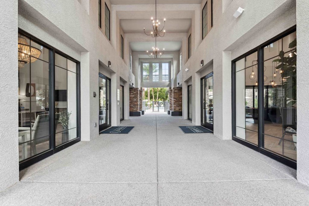 A long hallway with a white floor and white walls with black trim. at The Laurel Apartments, Chandler, AZ 85286