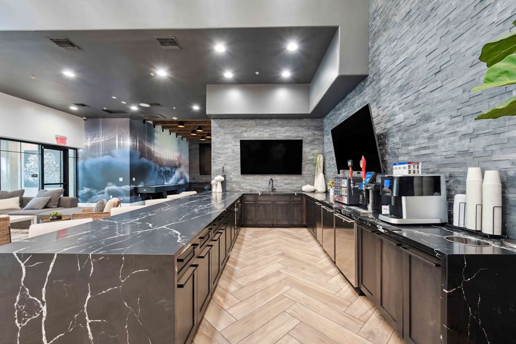 A modern kitchen with a marble countertop and wooden cabinets. at The Laurel Apartments, Chandler, 85286