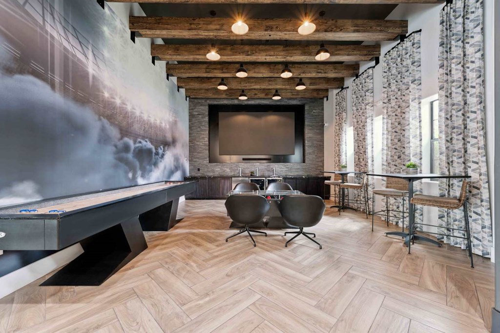 A room with a pool table and a television. at The Laurel Apartments, Chandler