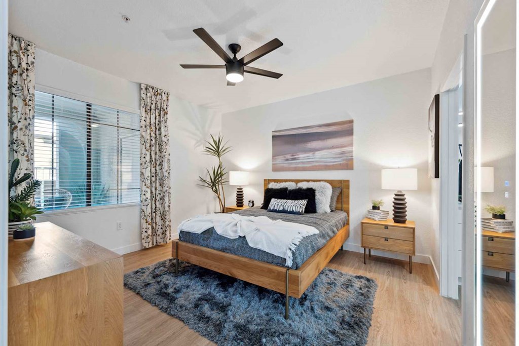 A bedroom with a large bed and a ceiling fan at The Laurel Apartments, Chandler, 85286  .