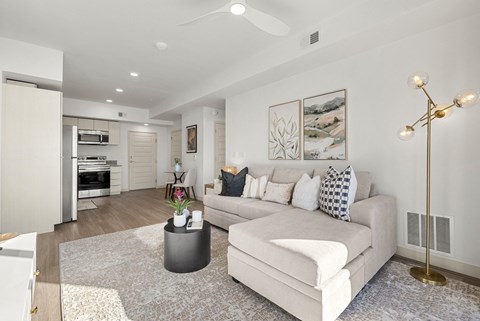 A modern living room with a white couch and a coffee table.