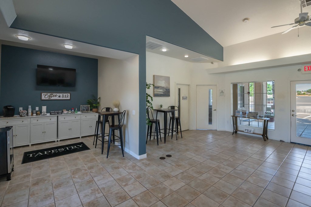 a clubhouse with a bar and a kitchen with stools
