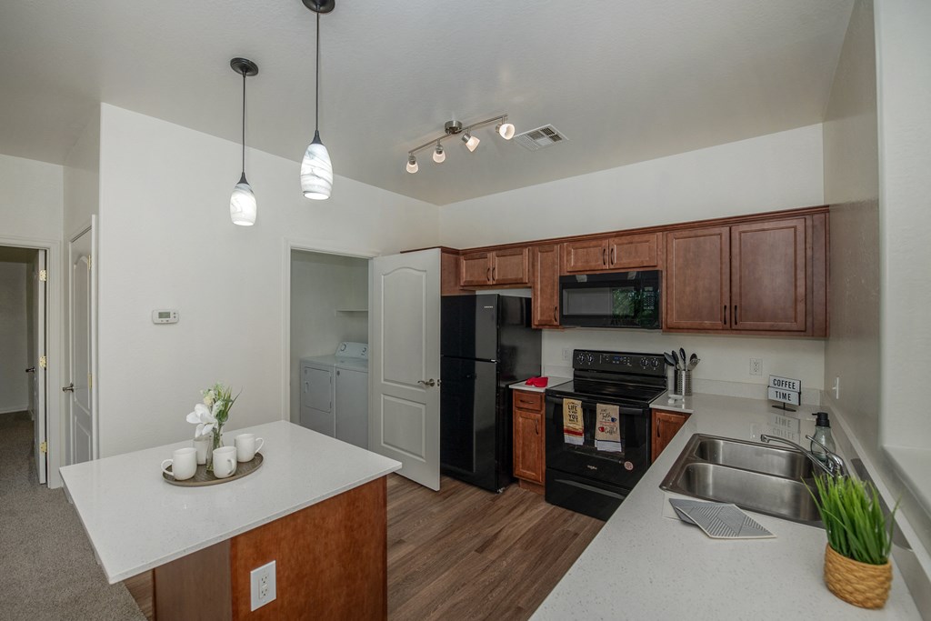 a kitchen with black appliances and a white counter top