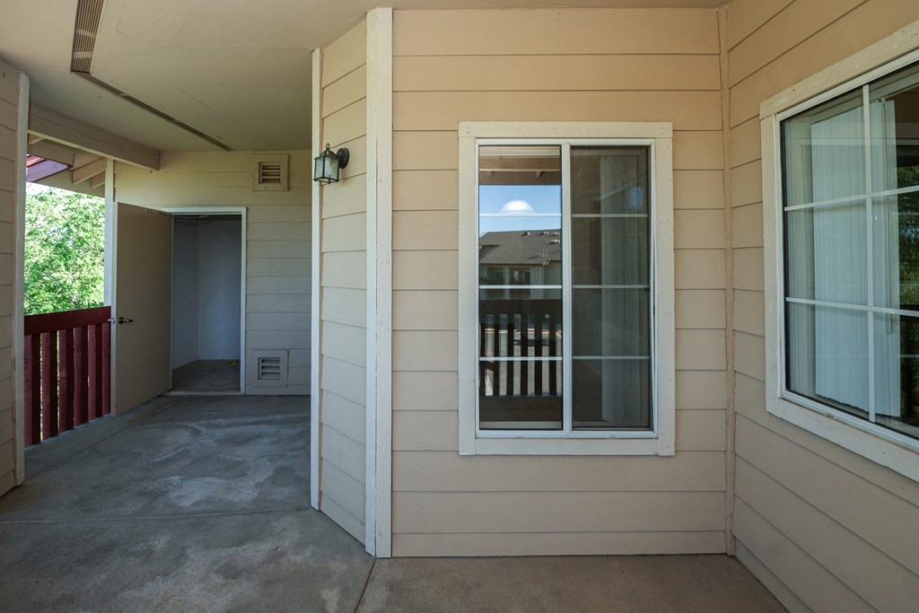 a view of the front porch of a house with a window